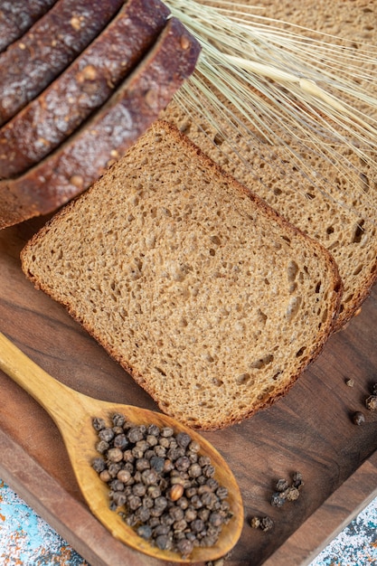 Slices of fresh loaf of bread on wooden board.