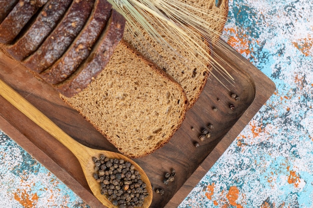 Slices of fresh loaf of bread on a wooden board