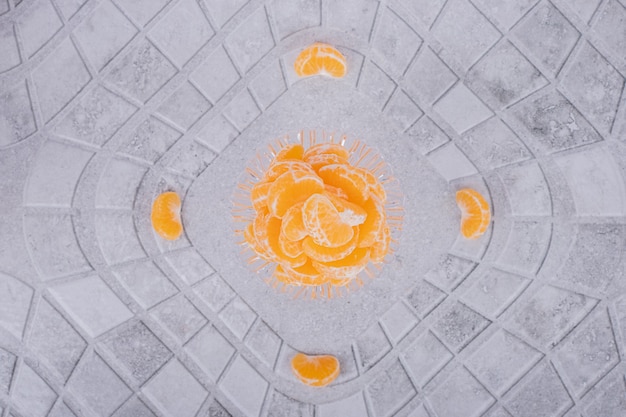 Slices of fresh tangerine on marble table.