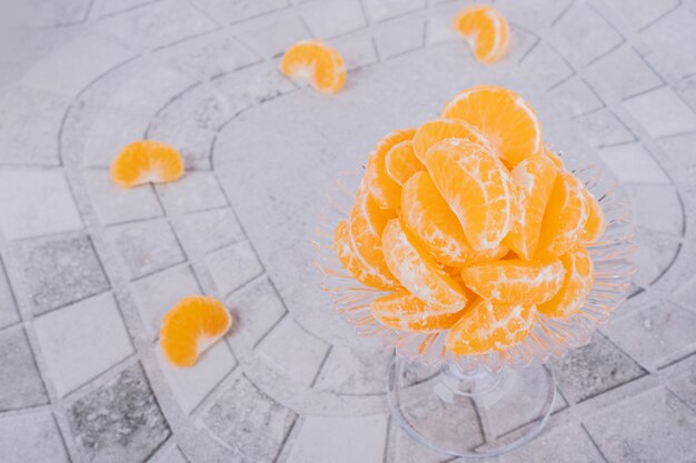 Slices of fresh tangerine on marble table.