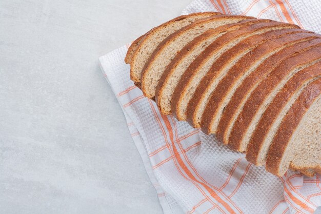 Slices of fresh white bread on tablecloth.