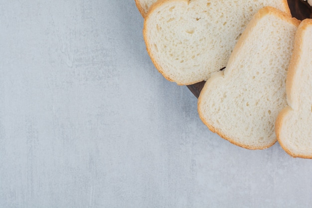 Slices of fresh white breads on marble background.