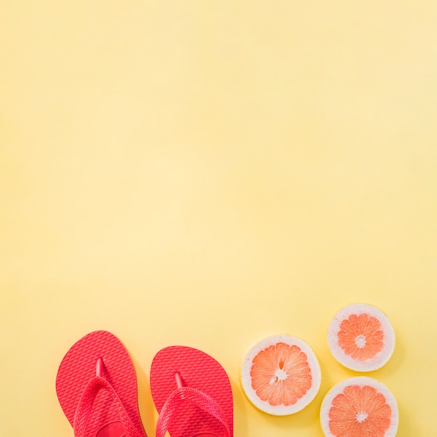 Slices of fruits near flip flops