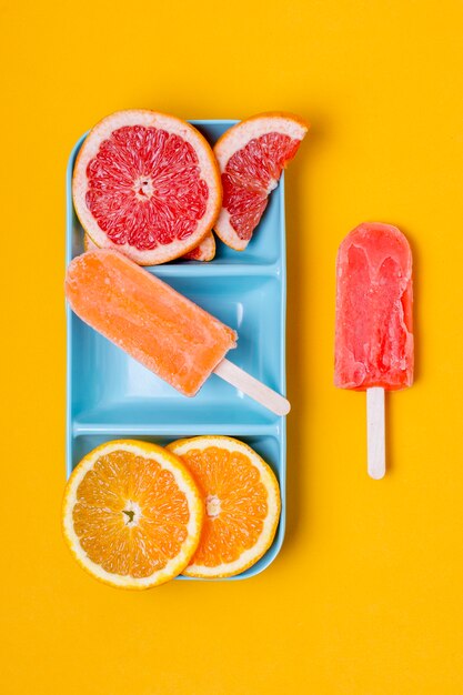 Slices of grapefruit and orange with ice cream top view