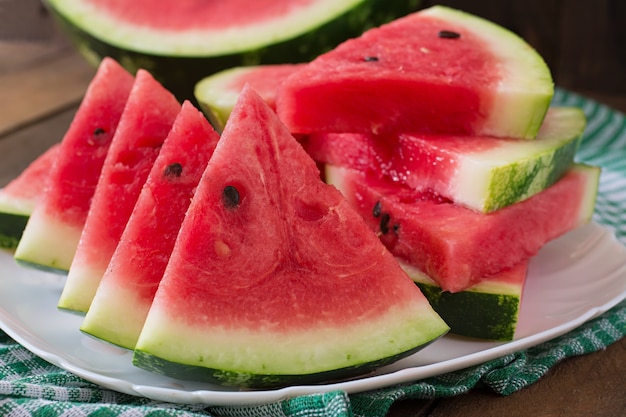 Slices of juicy and tasty watermelon on a white plate