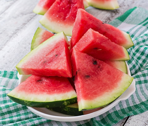 Slices of juicy and tasty watermelon on a white plate