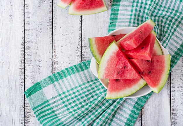 Slices of juicy and tasty watermelon on a white plate