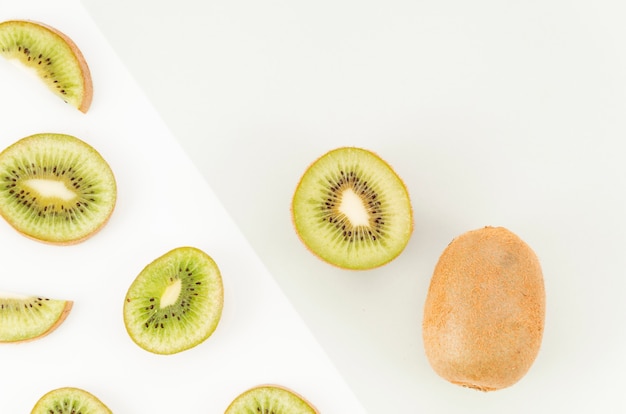 Slices of kiwi on light background