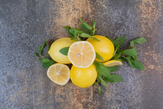 Slices of lemon with mint on marble surface