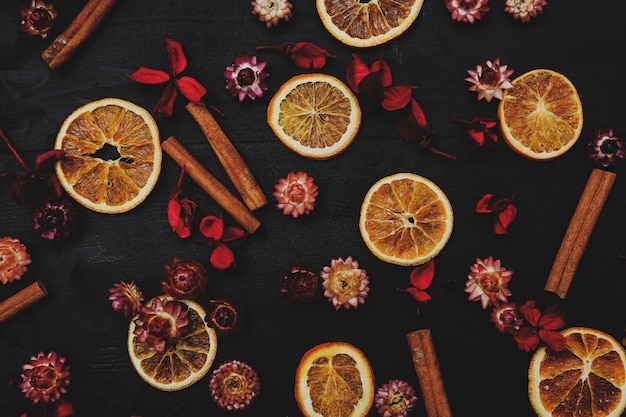 Slices of oranges, cinnamon and flowers