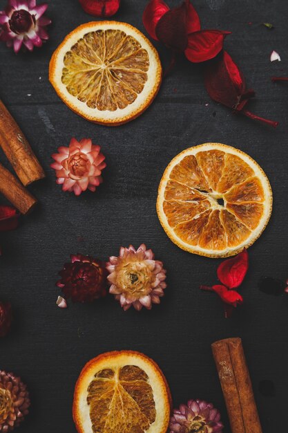 Slices of oranges, cinnamon and flowers