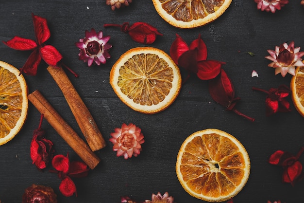 Slices of oranges, cinnamon and flowers