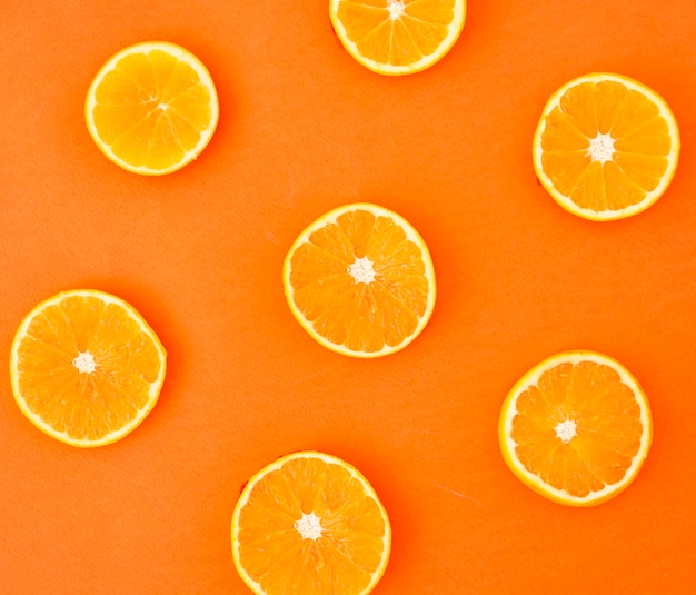 Slices of an oranges on colored background