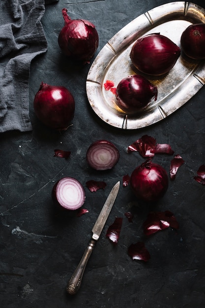 Slices of red onions on a black grunge background