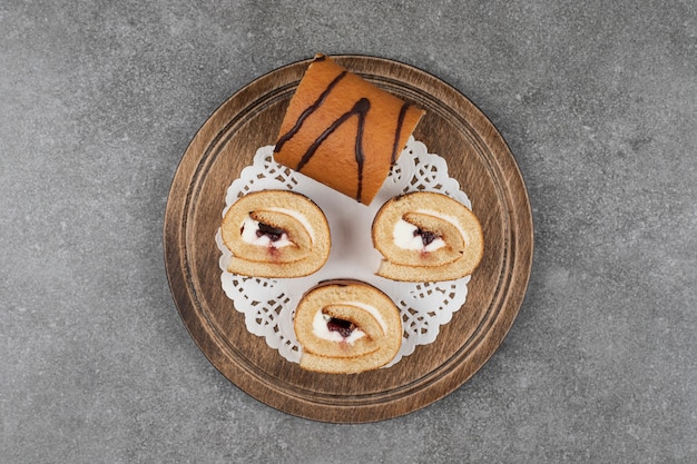 Slices of roll cake on wooden board