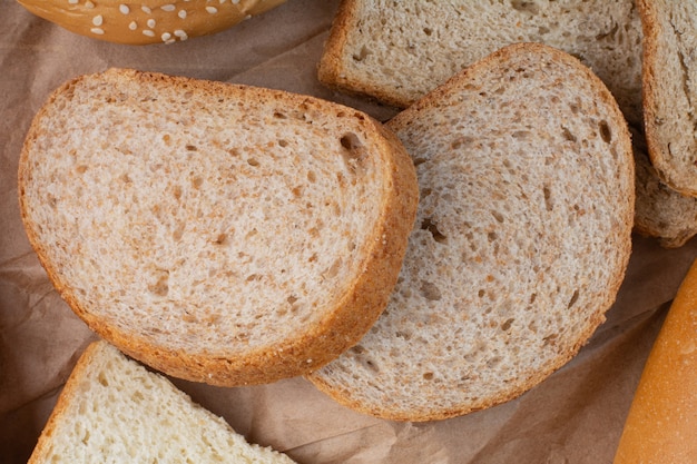 Slices of rye bread on stone surface