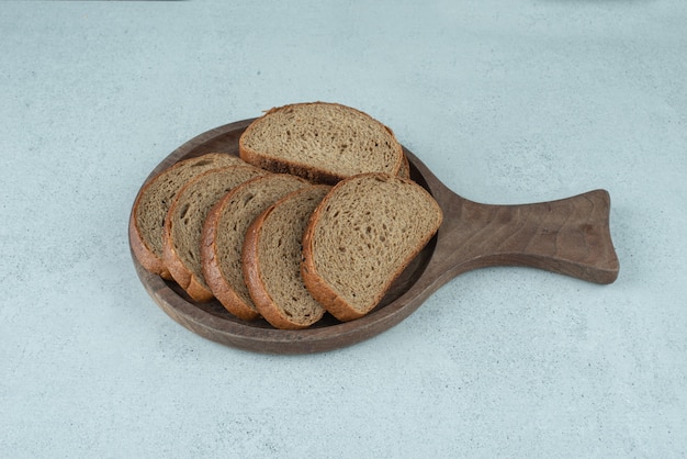 Slices of rye bread on wooden board