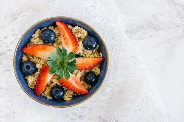 Slices of strawberry with cereals and blueberries