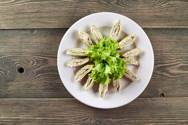 Slices of tasty armenian pita bread stuffed with cottage cheese and vegetables. Looks delicious. Good snack for light alcohol drinks.