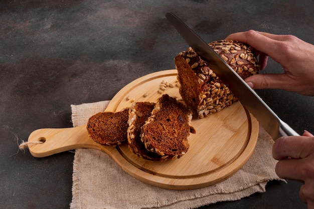 Slicing baked bread with knife