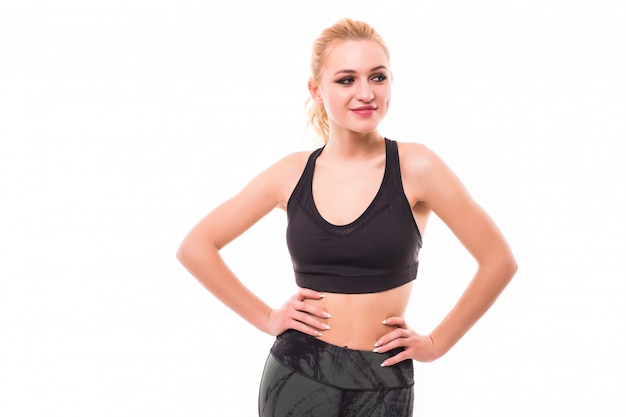 Slim aerobic woman posing on camera isolated on white wall