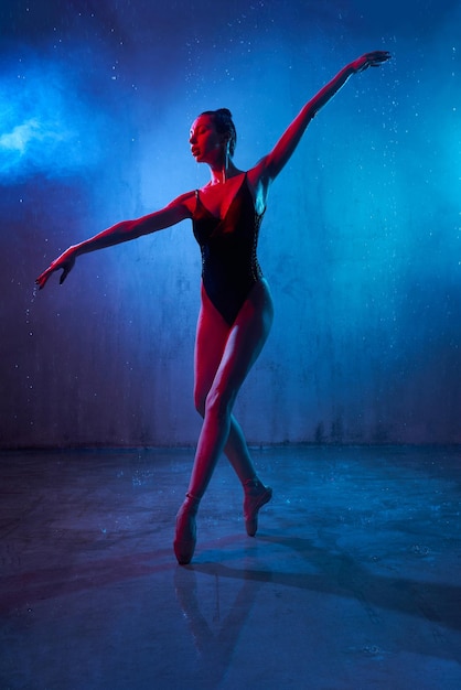 Slim ballerina dancing wearing pointes