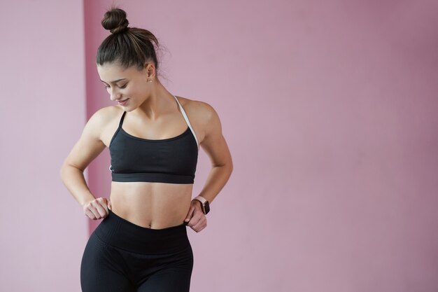 Slim beautiful woman posing on camera dressed in sportswear