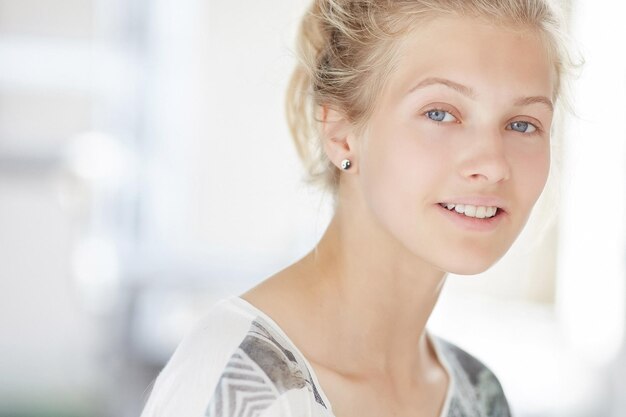 Slim blond woman in black and white shirt.