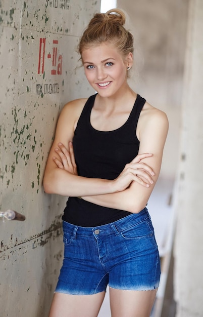 Free photo slim sexy woman in jeans shorts and black shirt.