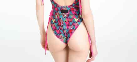 Free photo slim skinny woman buttocks body posing in pink printed swimsuit isolated on white studio