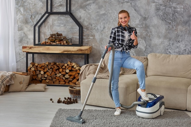 Slim woman cleaning with vacuum cleaner carpet in the house. Busy, cleaning day. Home, housekeeping concept