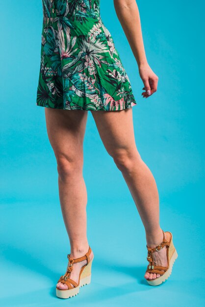 Slim young woman posing in flowered dress