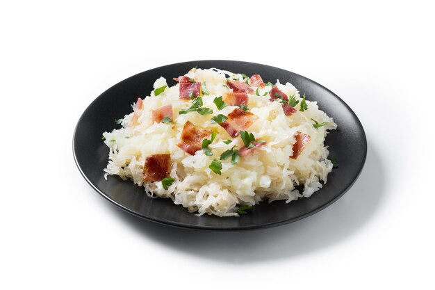Slovak potato dumplings halusky with steamed sauerkraut and bacon isolated on white background