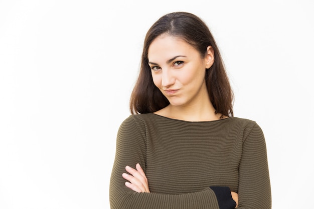 Sly smiling Latin woman with arms folded