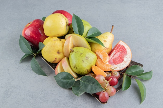 A small assortment of various fruits on marble 