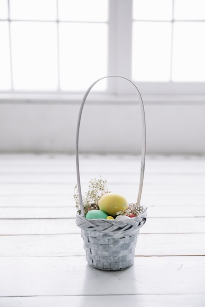 Free photo small basket with easter eggs