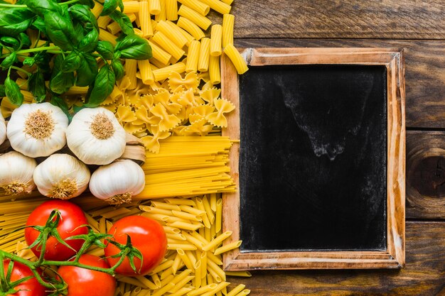 Small blackboard near pasta ingredients