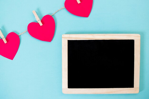 Small blackboard with garland of hearts