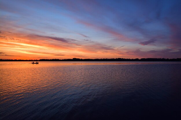 Small boat in the Draycote Water in England, the UK during a scenic sunset