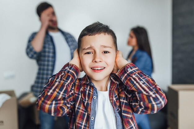 Small boy listening quarrel between parents