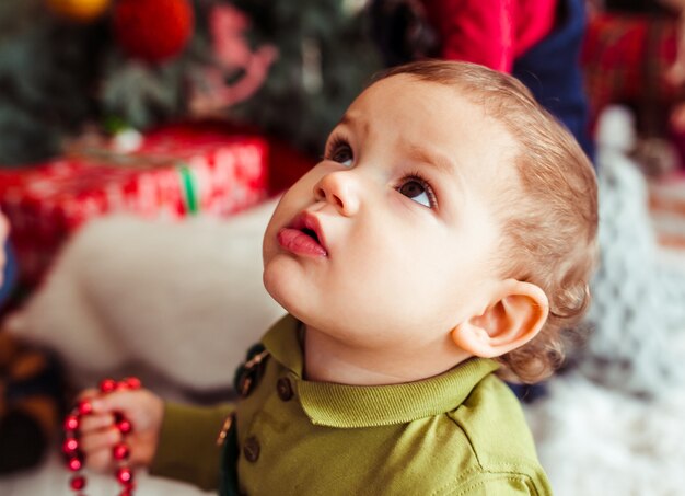 The small boy looking  at Christmas Tree