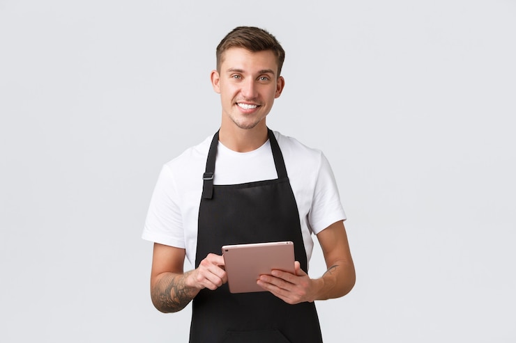 Free Photo small business coffee shop and cafe employees concept handsome charismatic smiling barista waiter in...