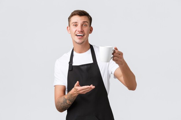 Small business coffee shop cafe and restaurants concept friendly handsome waiter barista selling dri...