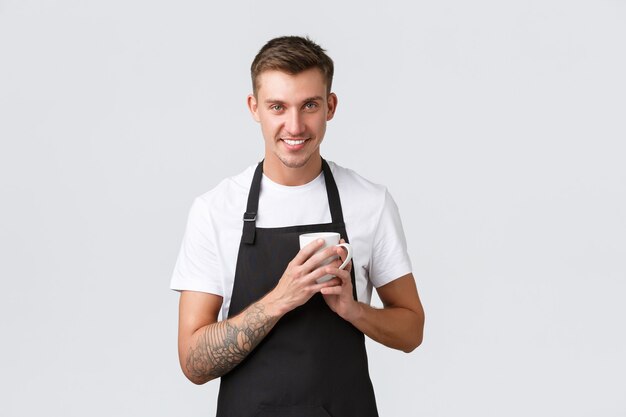 Small business coffee shop cafe and restaurants concept handsome barista enjoying making coffee hold...