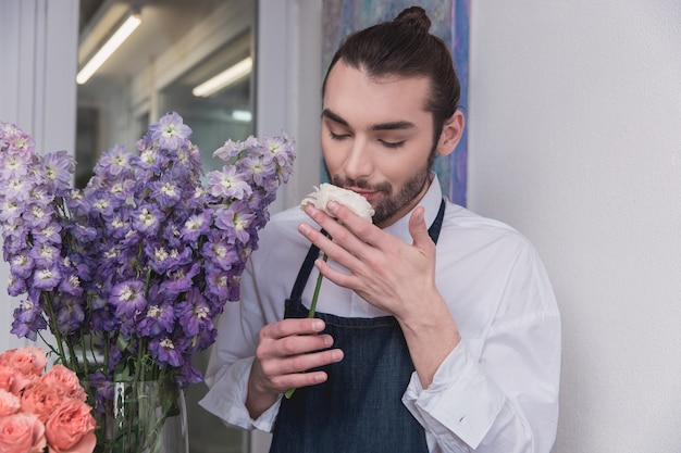 Small business. Male florist in flower shop.  making decorations and arrangements