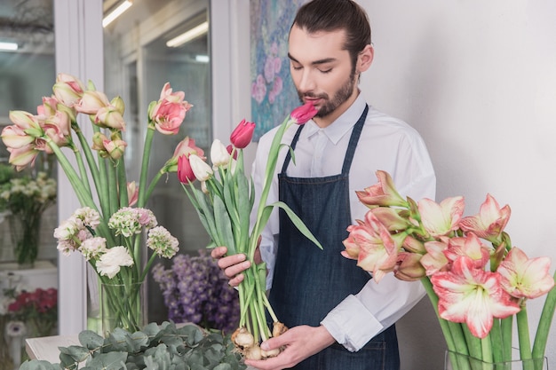 Small business. Male florist in flower shop.  making decorations and arrangements