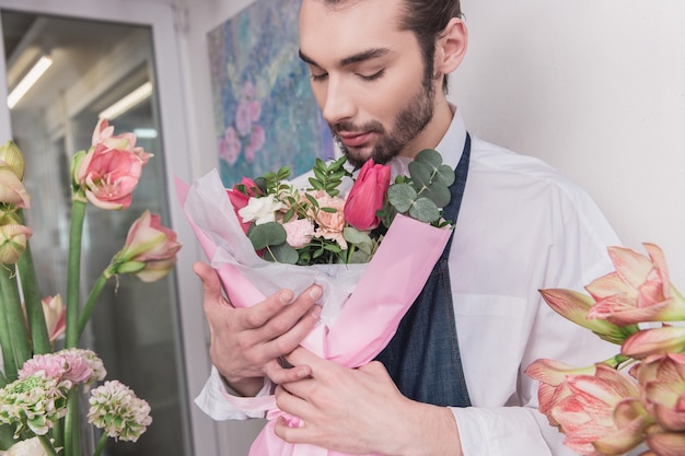 Small business. Male florist in flower shop.