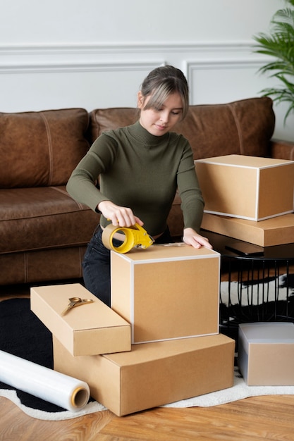 Small business owner packing product parcel boxes for delivery