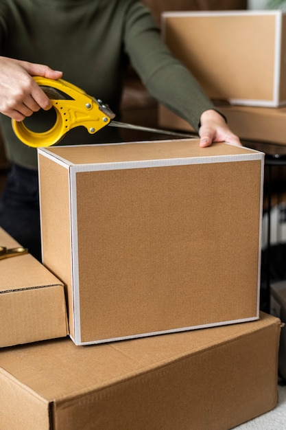 Free photo small business owner packing product parcel boxes for delivery