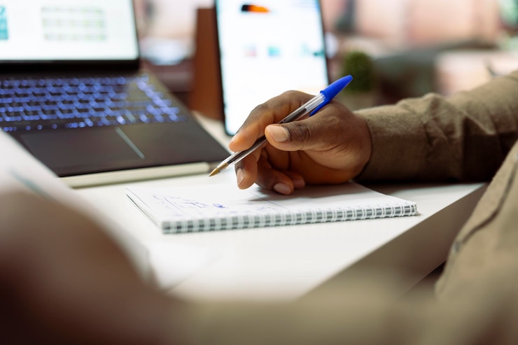 Free Photo small business owner works on monthly accounting balance on a notebook